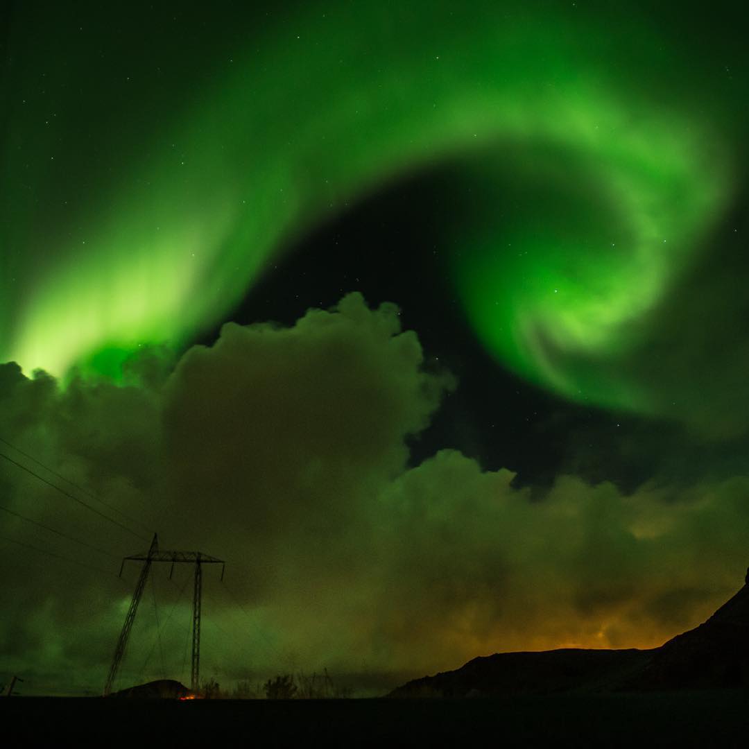 Spectacular northern lights over the highway in Iceland